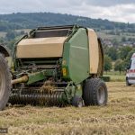 Tractor cu presă de baloți și ambulanță pe câmp